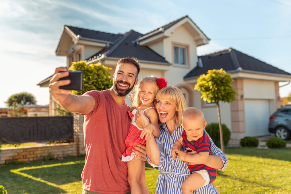 Family captures joy in front of new home as Sugar Land Movers assist relocation