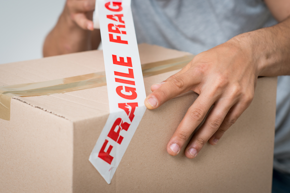 A box for fragile item packing marked with “fragile” tape.